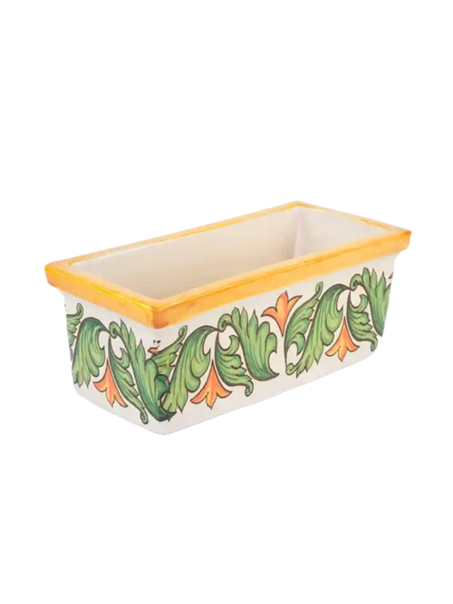 Un contenitore rettangolare in ceramica con un bordo giallo e un motivo floreale verde e arancione.